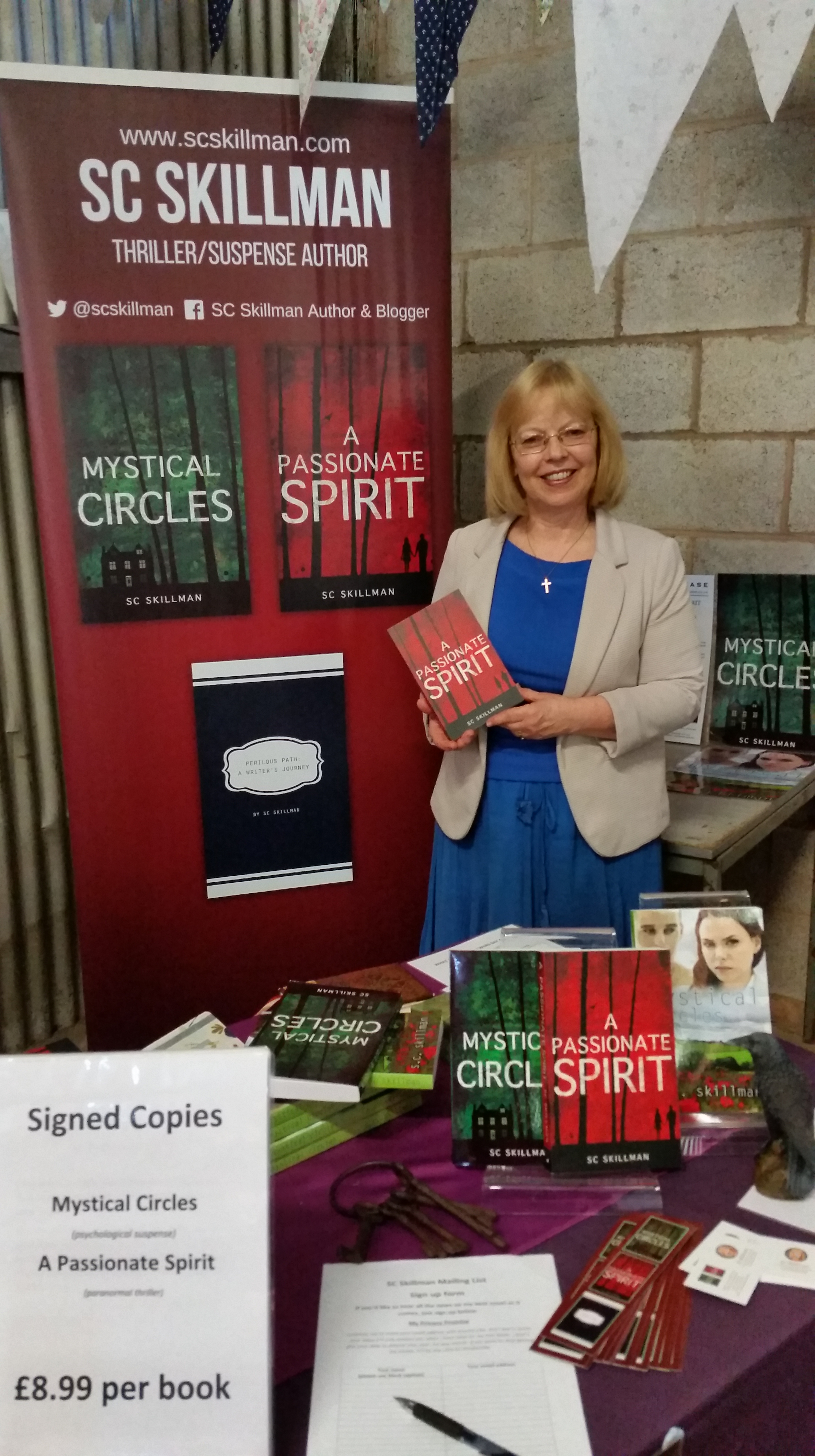 Author in blue holding book against burgundy banner
