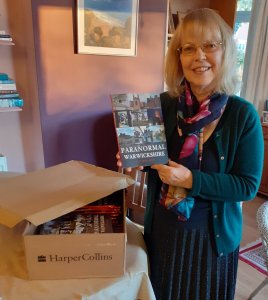 Author SC Skillman opening box of books Paranormal Warwickshire