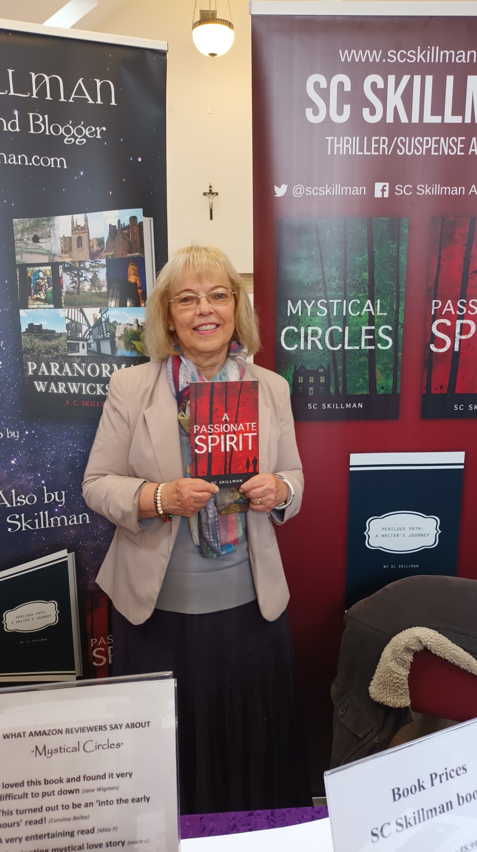 Author with book against banners